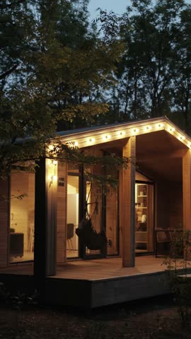 Experience the Cozy Modern Cabin at Dusk, Radiating Ambiance with Inviting Porch Lights. Vertical video