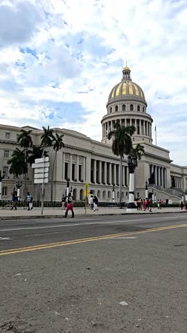 Traffic on central crossroad of Havana near the Capitol, people on the street of Havana, the old district of the capital of Cuba