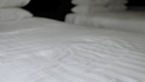 Housekeeping professional carefully folding pristine white towels while preparing hotel room bedding with meticulous workplace standards - Powered by Shutterstock - Get 15% off with code: PIKWIZARD15