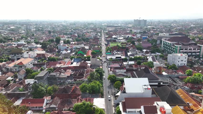 Traffic on the road in busy Indonesian city of Yogyakarta. Streets and urban area with buildings.