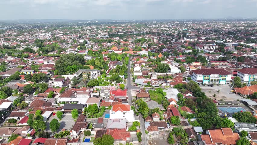 Yogyakarta big city in Java Island, Indonesia. Populated area with roof tops, buildings.