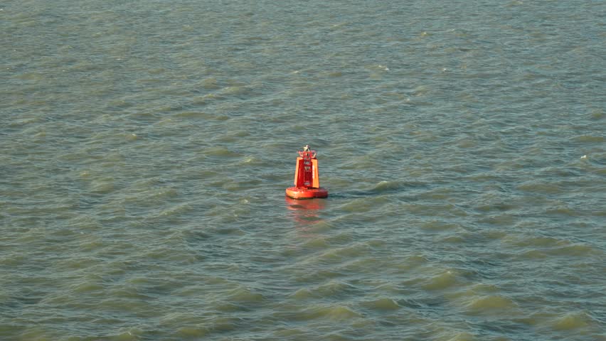 Red Port channel marker buoy. Coastal shipping channel navigation