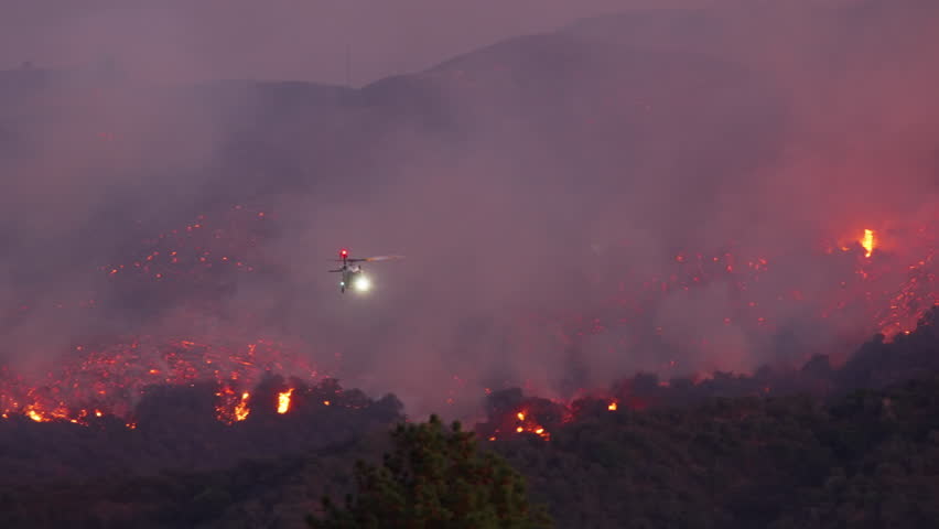 A heroic helicopter battles a massive fire in Malibu, Los Angeles, showcasing the dedication of all those fighting against this devastating disaster and its consequences. January 7, 8, 9, 2025