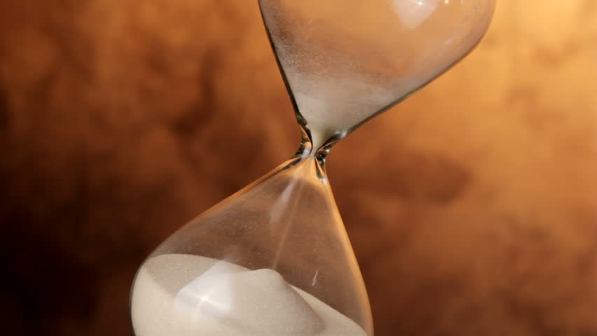 Hourglass shot on angle in HD video runs out of sand