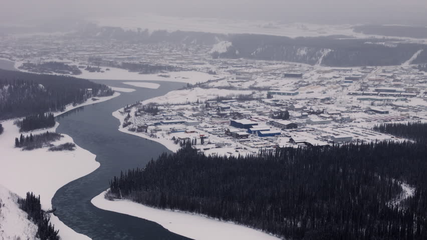 Whitehorse City In Winterly Landscape In Northwest Canada’s Yukon Territory. Aerial Drone Shot