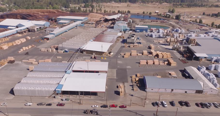 Aerial view of a sawmill in California on a sunny day, showcasing industry