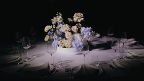 There is a bouquet of fresh flowers on the festive table in the semi-darkness. The bouquet is located in the middle of the table - Powered by Shutterstock - Get 15% off with code: PIKWIZARD15