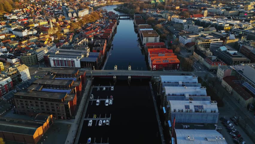 Trondheim, Norway, comes alive in Winter Serenade, showcasing its vibrant cityscape, colorful houses, riverboats, traffic bridges, and stunning architecture from a drone