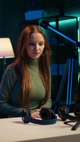 Vertical video Young content creator films video review of book, browsing through pages, presenting synopsis to audience. Internet star sponsored by publisher to show new novel release to readers