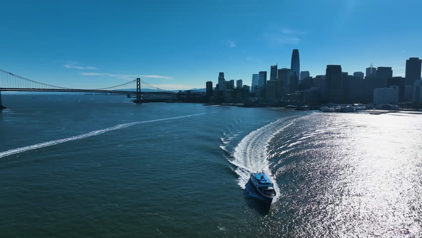 Aerial view of ferry with San Francisco skyline background, sunny day in CA, USA