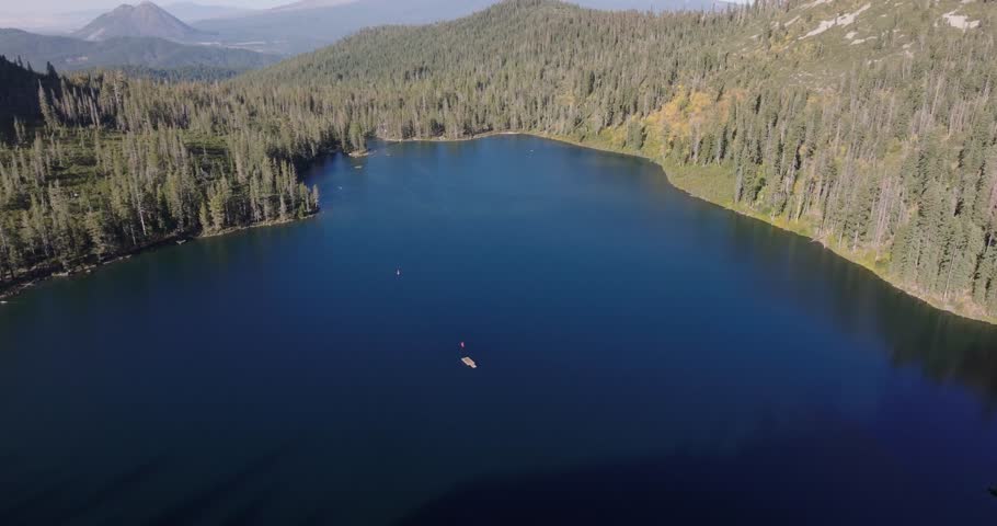 Aerial medium tilt up over Castle Lake in Shasta California USA with Mountain peak centered