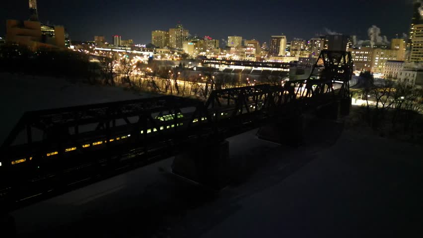 VIA Rail The Canadian passenger trains arrives into Winnipeg on cold winter night, drone aerial