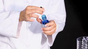 Scientist adds dye to beaker for experiment - Powered by Shutterstock - Get 15% off with code: PIKWIZARD15