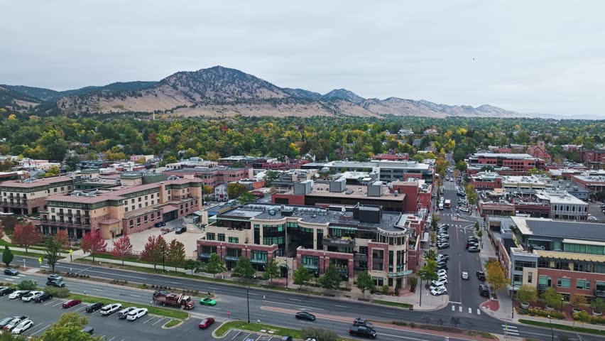 Iconic Flatirons with Downtown Boulder Colorado autumnal scenery, vibrant neighborhoods, and trendy urban areas in aerial overview