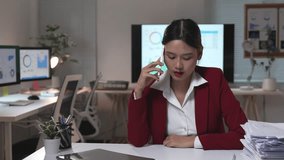 Asian businesswoman having a phone call and then crossing arms, sitting at her desk in the office - Powered by Shutterstock - Get 15% off with code: PIKWIZARD15