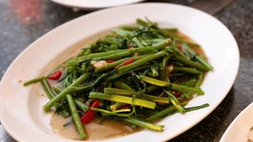 Delicious Thai stir-fried morning glory served - Powered by Shutterstock - Get 15% off with code: PIKWIZARD15
