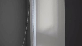 A man opens roller blinds, installing and operating windows in a house  - Powered by Shutterstock - Get 15% off with code: PIKWIZARD15