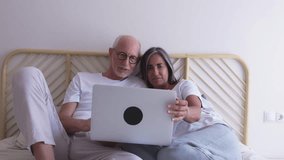 Happy retired couple using laptop computer in bed, enjoying online shopping and social media. 4k resolution video.
 - Powered by Shutterstock - Get 15% off with code: PIKWIZARD15