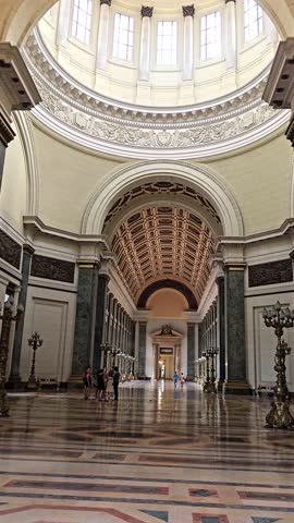 Long white hall consisting of columns and arches. View inside the capitol, tour of the capitol building in havana, cuba