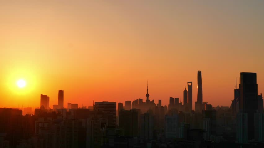 Sunrise Over Shanghai Skyline With Lush Colors Illuminating Urban Landscape