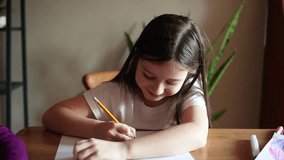 child girl sits at the table at home and dreams, looks up and figures out what to draw. ideas and inspiration for creativity - Powered by Shutterstock - Get 15% off with code: PIKWIZARD15