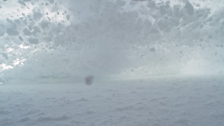 Snow avalanche sliding down a mountainside and crush into camera , super slow motion