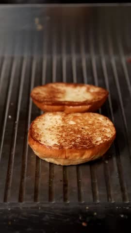 A gourmet burger masterpiece: juicy veal patty topped with cheddar cheese, spicy peppers, and creamy sauce on a toasted bun. A savory treat for burger enthusiasts