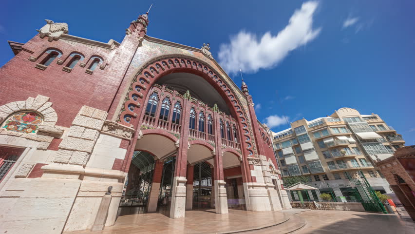 Mercado de Colon facade timelapse hyperlapse in Valencia, Spain, showcasing stunning Art Nouveau architecture. Popular tourist attraction with shops and cafes in a beautifully restored market building