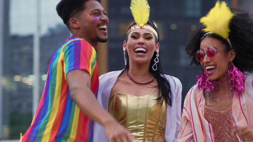 Excited Friends Throwing Confetti at a Brazilian Carnival Street Party. Joyful Group in Colorful Costumes Celebrating Vibrant Carnaval Festivities Outdoors in the City