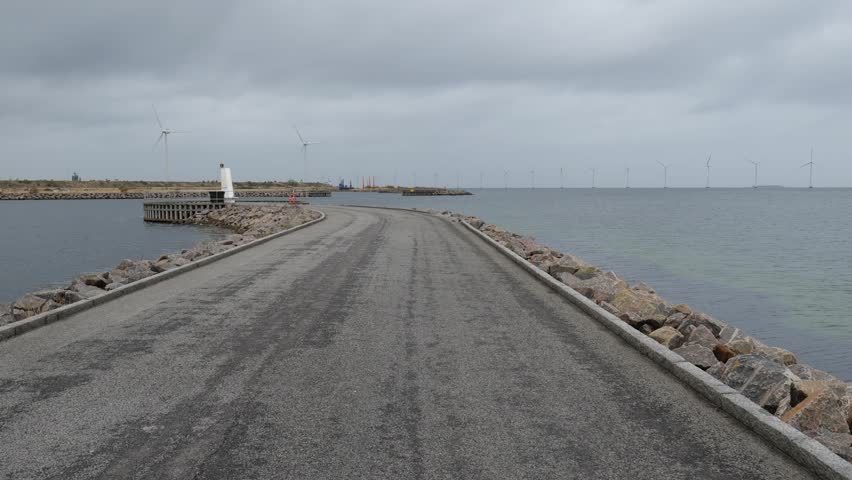 Walking on the asphalt road near the sea. Beautiful landscape around
