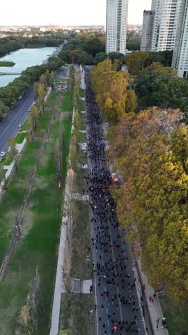 Aerial View of People Running in Race on Avenue with Park and River Sides