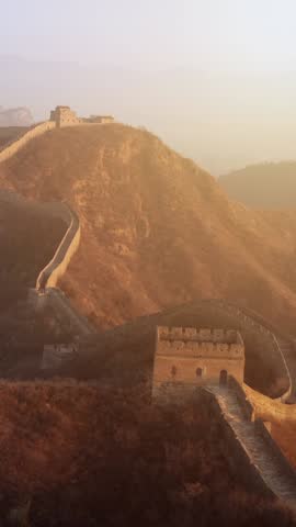 Flying over the Great Wall of China at sunrise. Vertical Video,