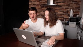 Young wife and husband are sitting at home with laptop, papers, looking at documents, checks, analyzing expenses together. Analysis of money spending in online stores.  - Powered by Shutterstock - Get 15% off with code: PIKWIZARD15
