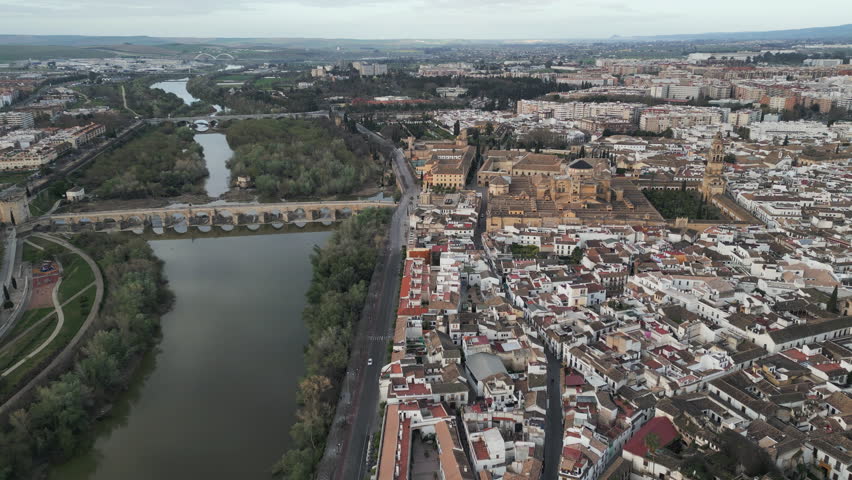 Aerial capture unveils panorama of Cordoba, a historic town nestled on the bank of Guadalquivir River in the heart of Andalusia, a province in southern Spain. Flying forwards.