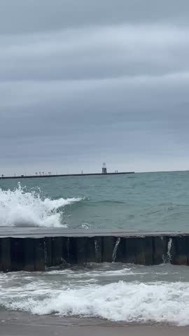 The serene beauty of Lake Michigan with waves crashing gently along the shore, offering a peaceful escape from the vibrant city of Chicago.