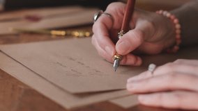young woman writes a letter with an ink pen. A woman writes a letter with a quill. - Powered by Shutterstock - Get 15% off with code: PIKWIZARD15
