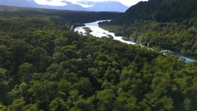 Aerial View of a River Meandering through a Dense Forest with Mountains in the Background - Powered by Shutterstock - Get 15% off with code: PIKWIZARD15