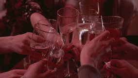 Group of guests celebrate and raise glasses, toasting and cheering with alcohol glasses with wine and champagne in the restaurant on corporate christmas birthday party event or wedding celebration - Powered by Shutterstock - Get 15% off with code: PIKWIZARD15