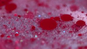Sparkling bubbles. Glitter paint mix. Blur red color shiny sequin particles ink drops transparent gel fluid spill motion abstract art background with bokeh lights. - Powered by Shutterstock - Get 15% off with code: PIKWIZARD15