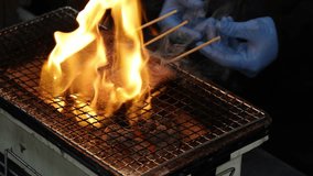 Chef grilling skewered Japan Wagyu beef or meat with a fire blowtorch. Close up of delicious grilled on the meat by grill pan and blow torch. Street food preparation with vibrant hot flames in Japan - Powered by Shutterstock - Get 15% off with code: PIKWIZARD15
