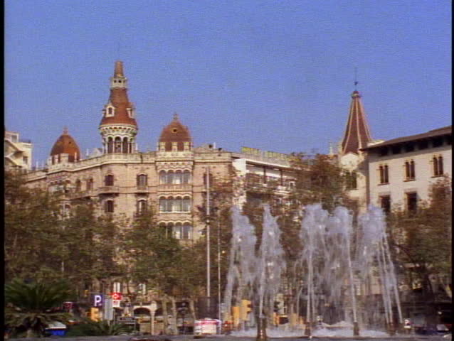 Barcelona, Spain, a fountain and a castle like downtown building
