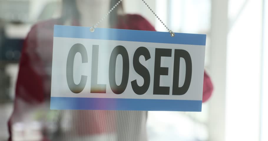 Business closures in the center are welcomed by the sign open instead of closed. Closed, turning open sign board on glass door