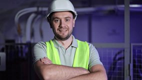 Confident electrical engineer in a server room. Bearded man wearing a hardhat and high-visibility vest. Industrial environment with electrical switchboards and control panels. - Powered by Shutterstock - Get 15% off with code: PIKWIZARD15