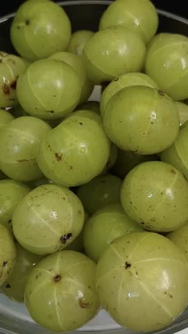 Fresh Indian gooseberry or amla in a glass bowl. Fresh gooseberry isolated.