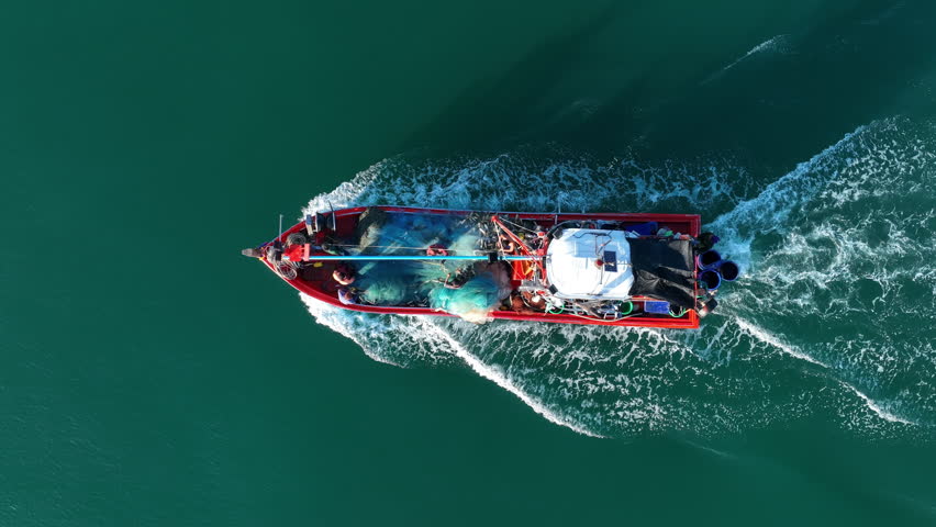  Fishing boat in the ocean for catching fish all a long night - at Thailand. Top view of Fishing Boat running verry fast on the sea to port