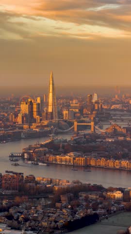 Golden sunrise time lapse view of the urban skyline of London, England, with City skyscrapers and River Thames