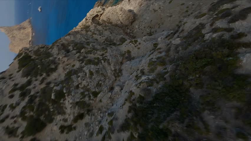 Drone fpv flies through the rocks of the camel cave in Marettimo in Sicily
