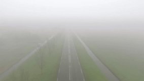 Aerial of cars on 2 lane road in thick fog or mist - Powered by Shutterstock - Get 15% off with code: PIKWIZARD15