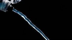 Blue Isotonic Sport Water Pours From The Bottle, With Drops And Splashes Captured In Slow Motion - Powered by Shutterstock - Get 15% off with code: PIKWIZARD15