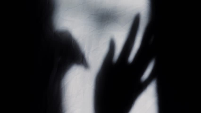 Blurred shadows on a white wall. Shadow of dancing hands. High quality 4k footage